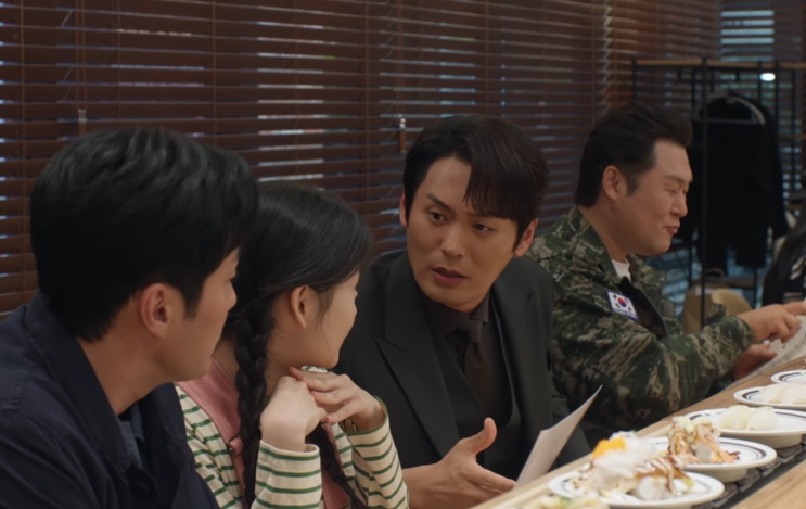 Sung Han-soo e Park Jin-cheol conversando à mesa de um restaurante, com Kim e Minji